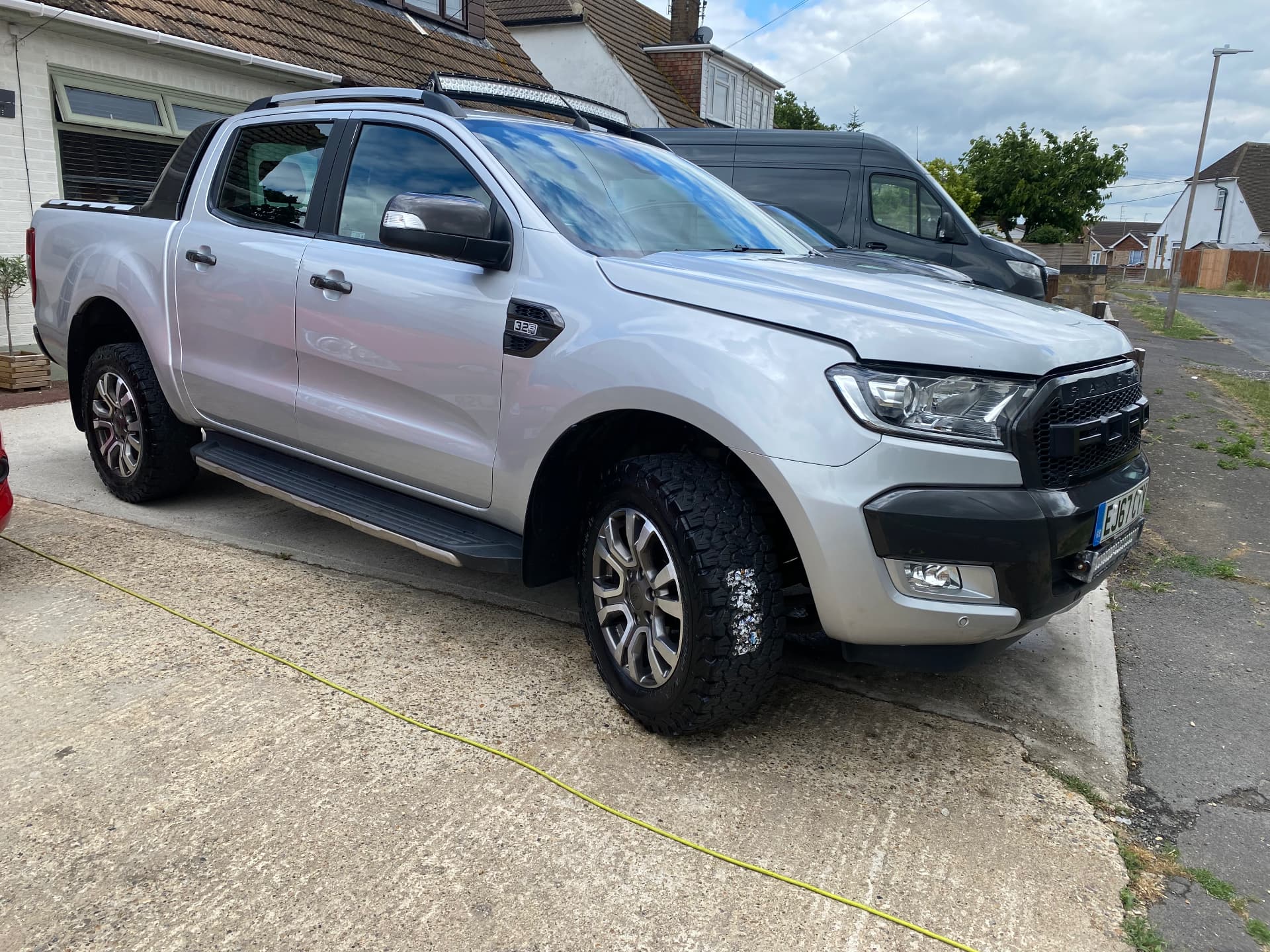 Silver Ford Ranger Wildtrak washed to a bright finish on a driveway