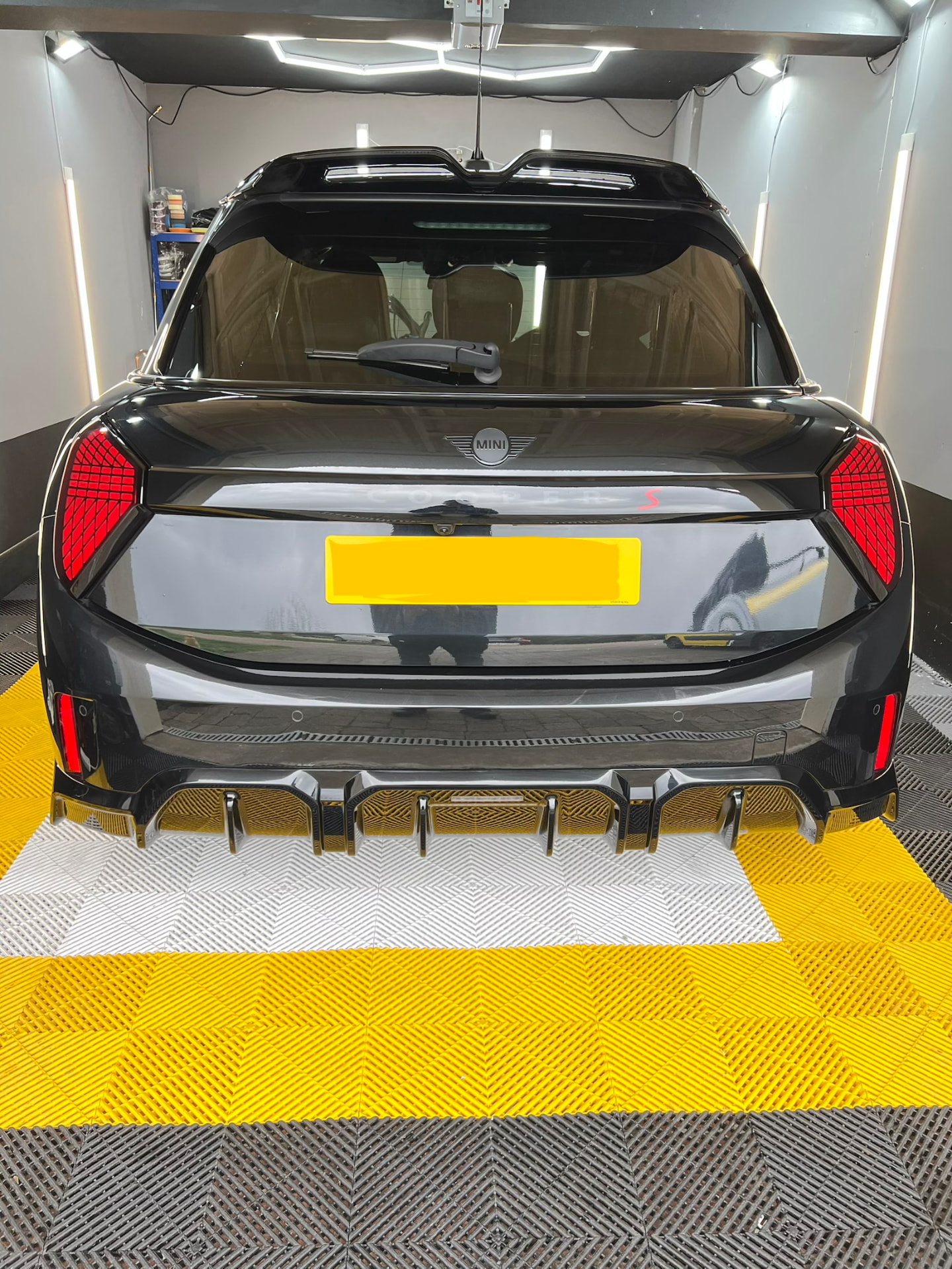 Black Mini Cooper S detailed under hex lighting in the Daws Heath unit