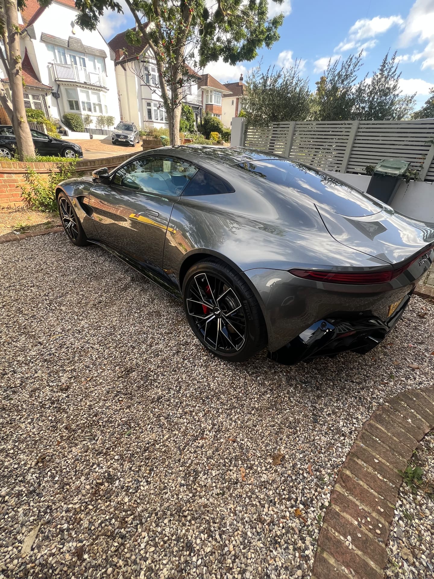 Silver Aston Martin Vantage detailed to a deep gloss on a gravel driveway
