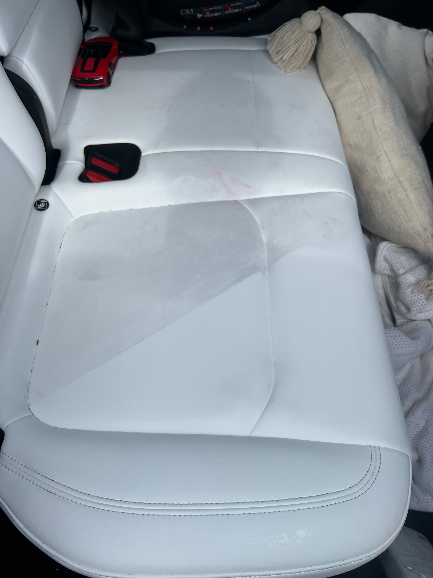 White leather rear seats marked and stained before interior cleaning