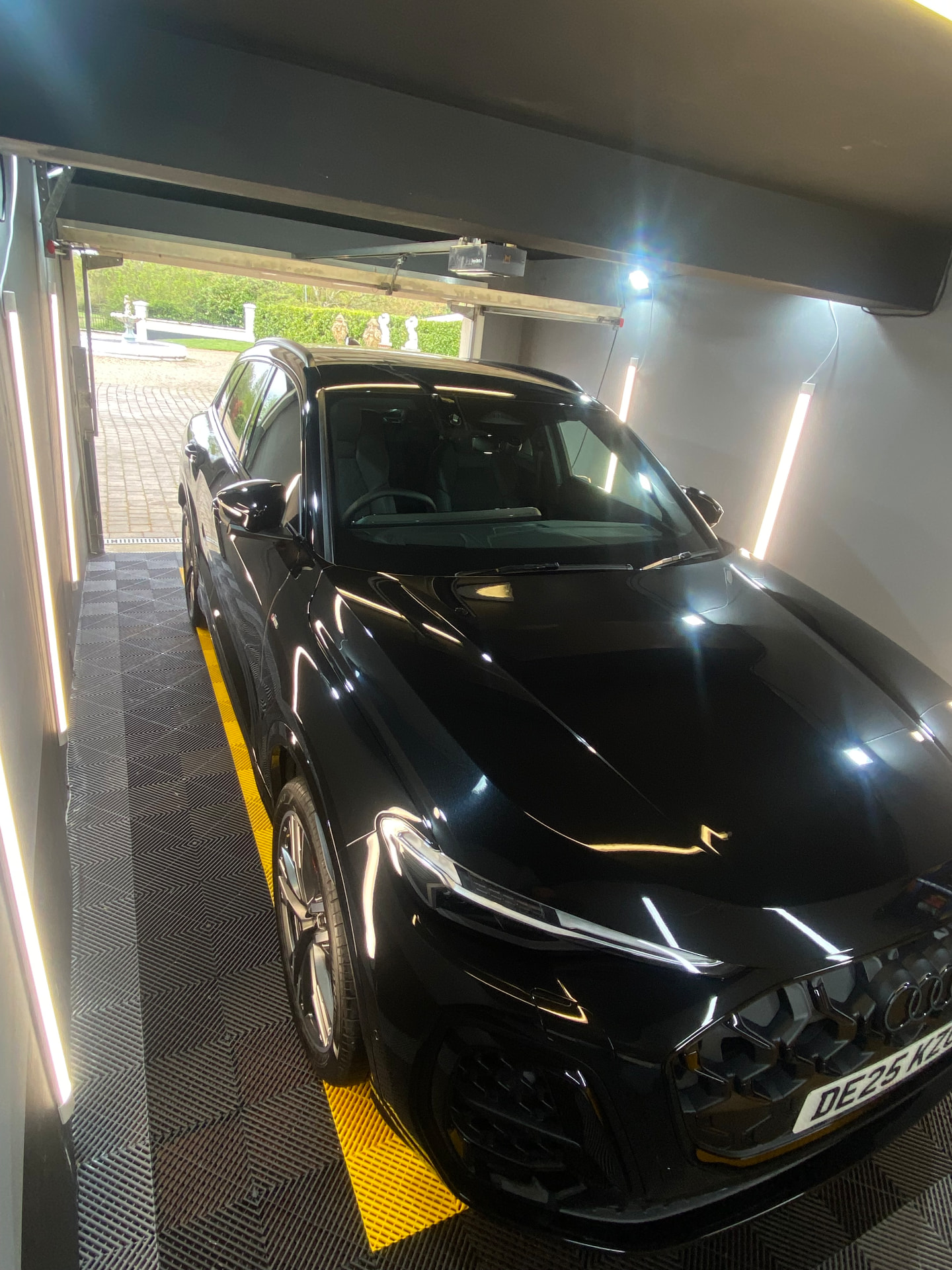 Black Audi SQ5 with a mirror-gloss finish inside the detailing unit