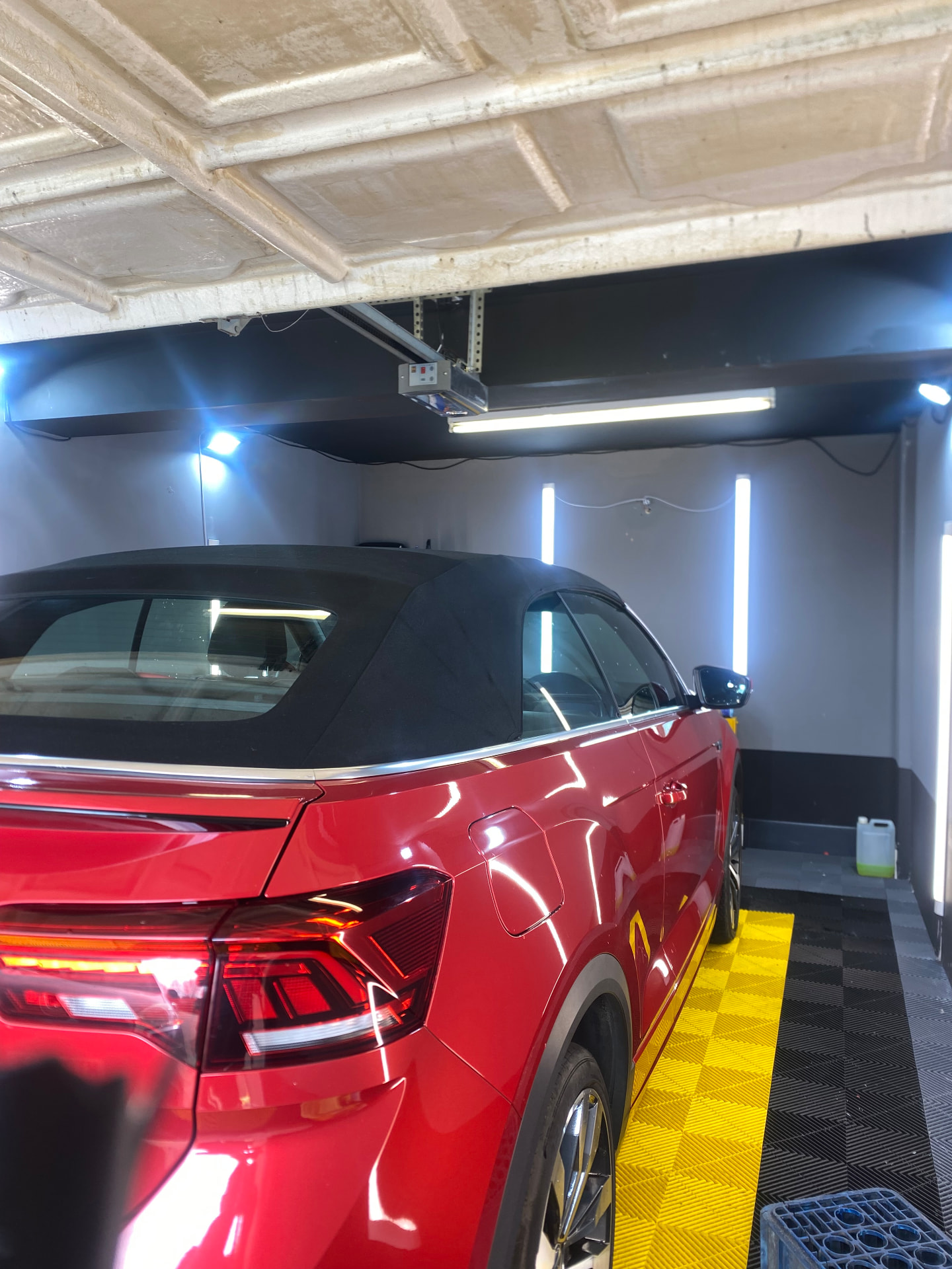 Red VW T-Roc cabriolet detailed under the lights in the Daws Heath unit