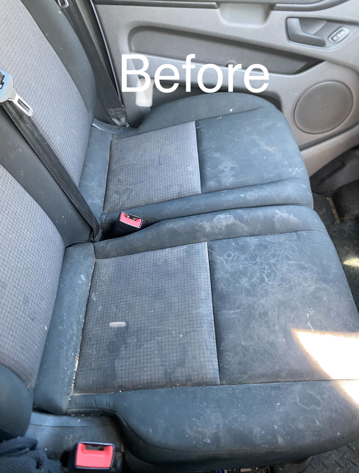 Stained fabric van rear seats before interior cleaning