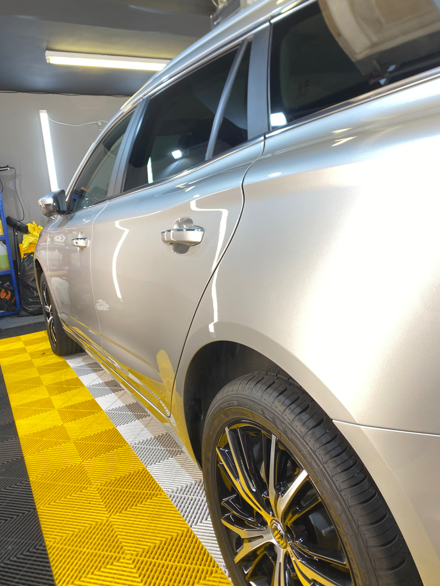 Silver estate car with a flawless polished flank inside the unit