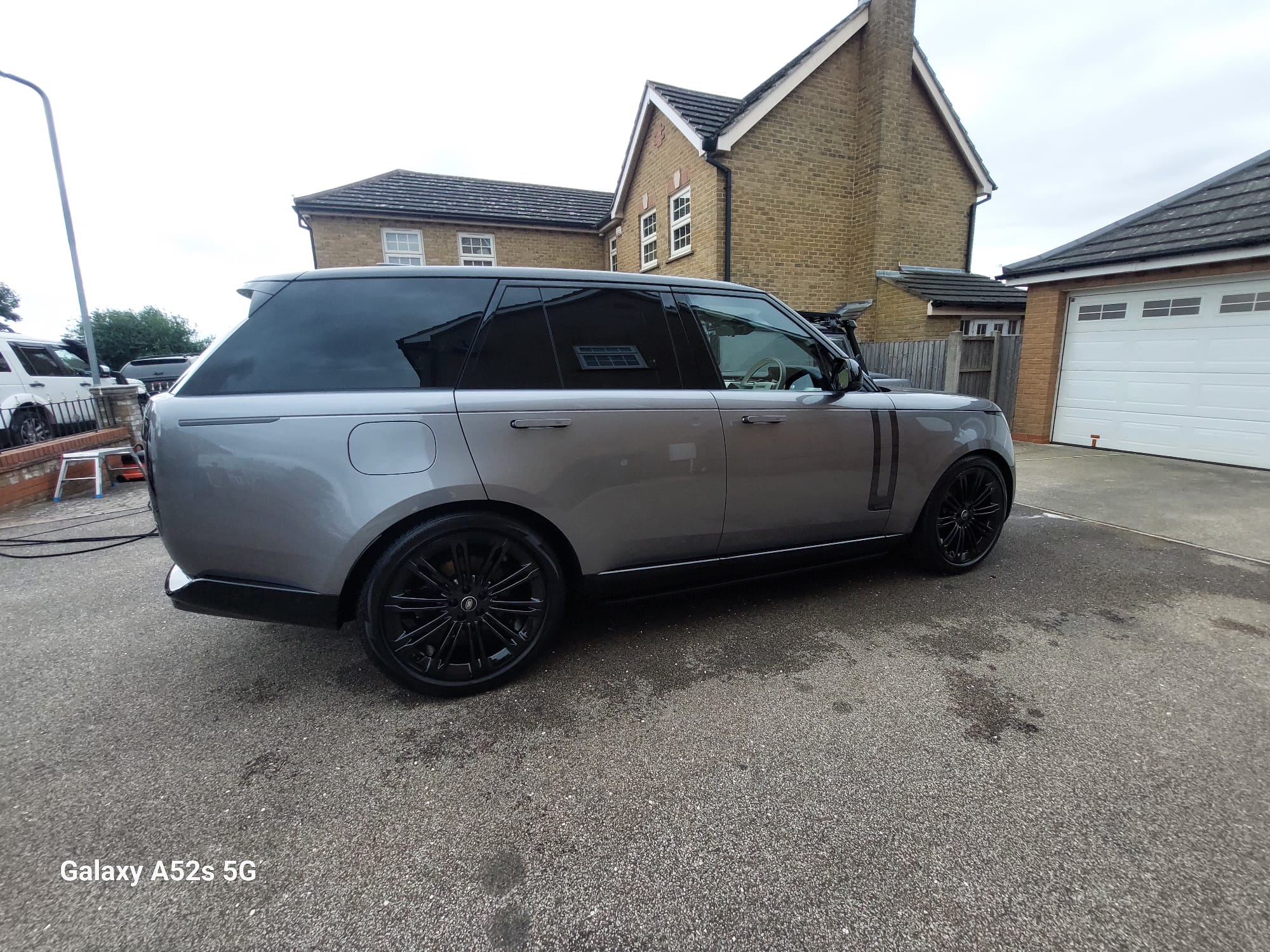 Grey Range Rover with black alloys gleaming after a full valet