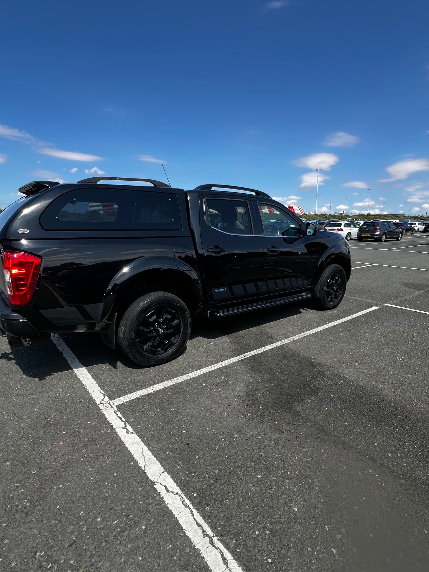 Black Nissan Navara pickup with a deep gloss finish after detailing